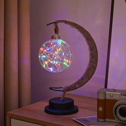 Stemningsfuld LED-bordlampe med glaskugle og halvmåne