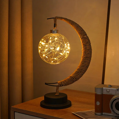 Stemningsfuld LED-bordlampe med glaskugle og halvmåne