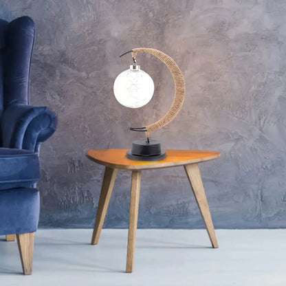Stemningsfuld LED-bordlampe med glaskugle og halvmåne